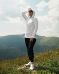 Woman wearing NAZCA WEAR Fjord Shadow Camo UPF 50+ Performance Sun Hoodie outdoors in the mountains